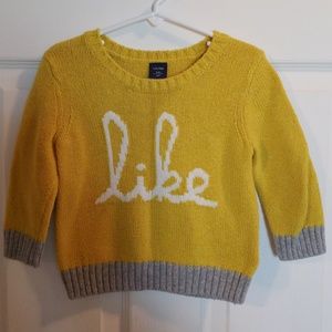 Yellow 'Like' sweater.